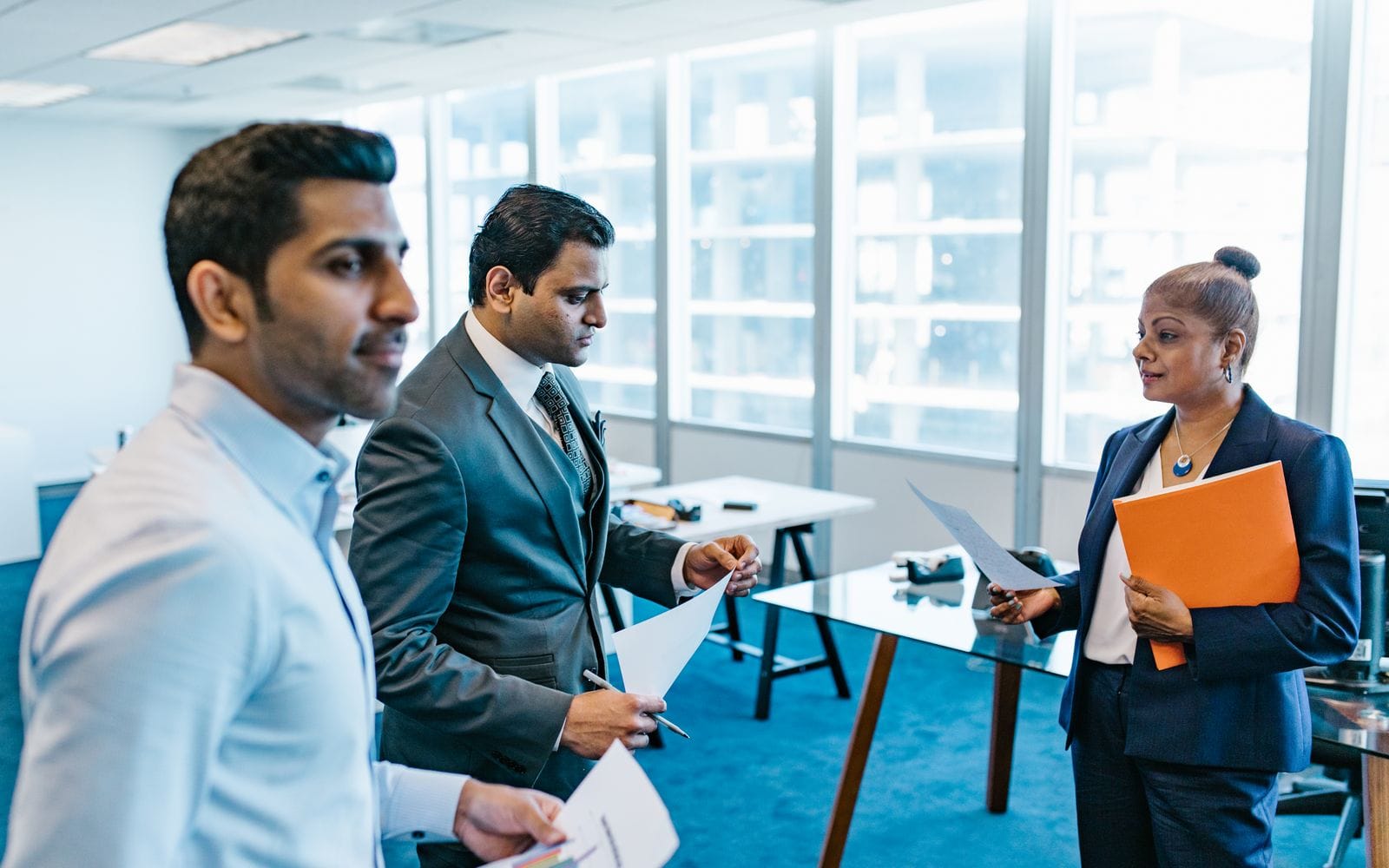 A senior real estate broker discussing commission agreements with a commercial property developer in an office