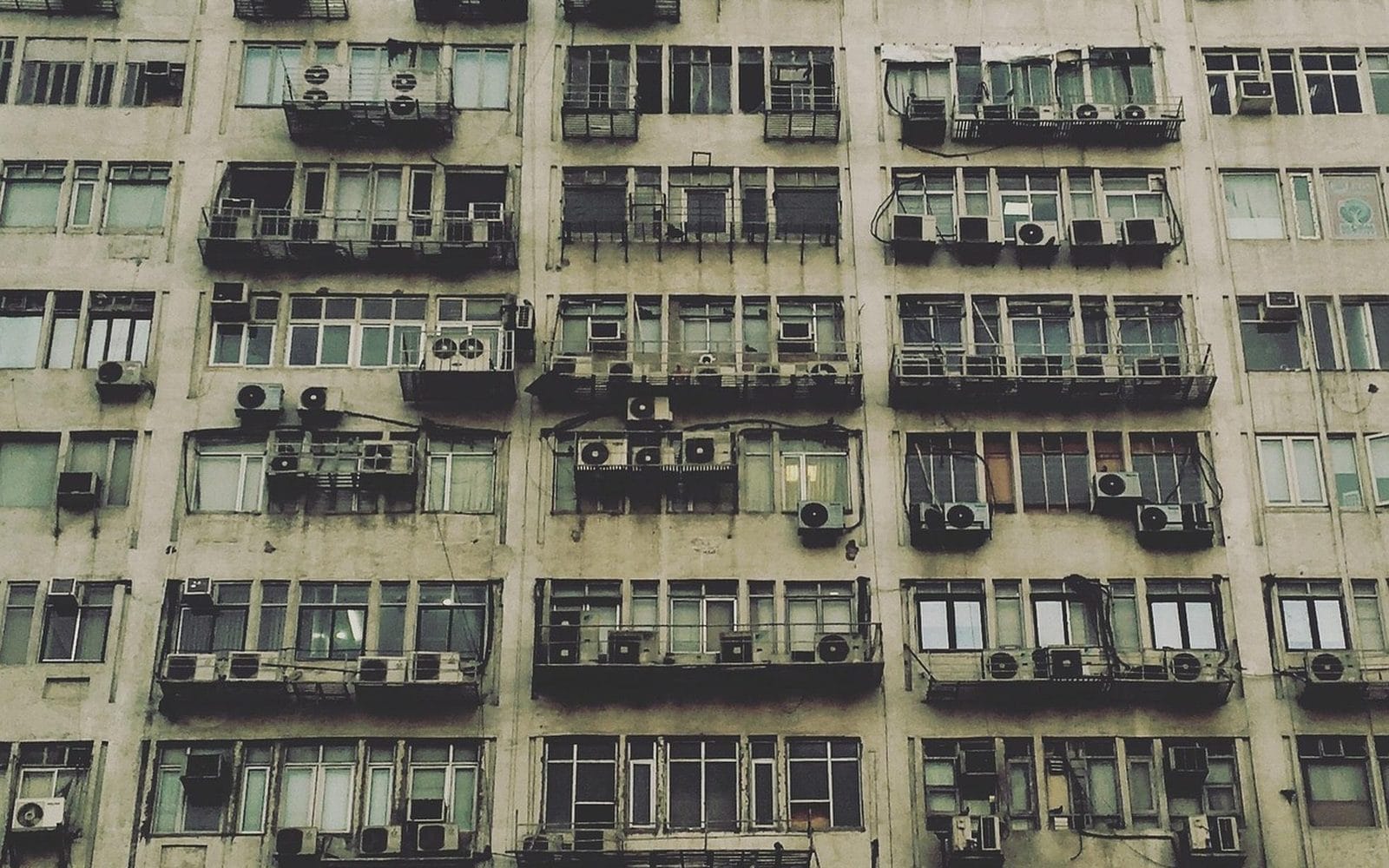 Rows of apartment balconies with air conditioners on a high-rise in Delhi