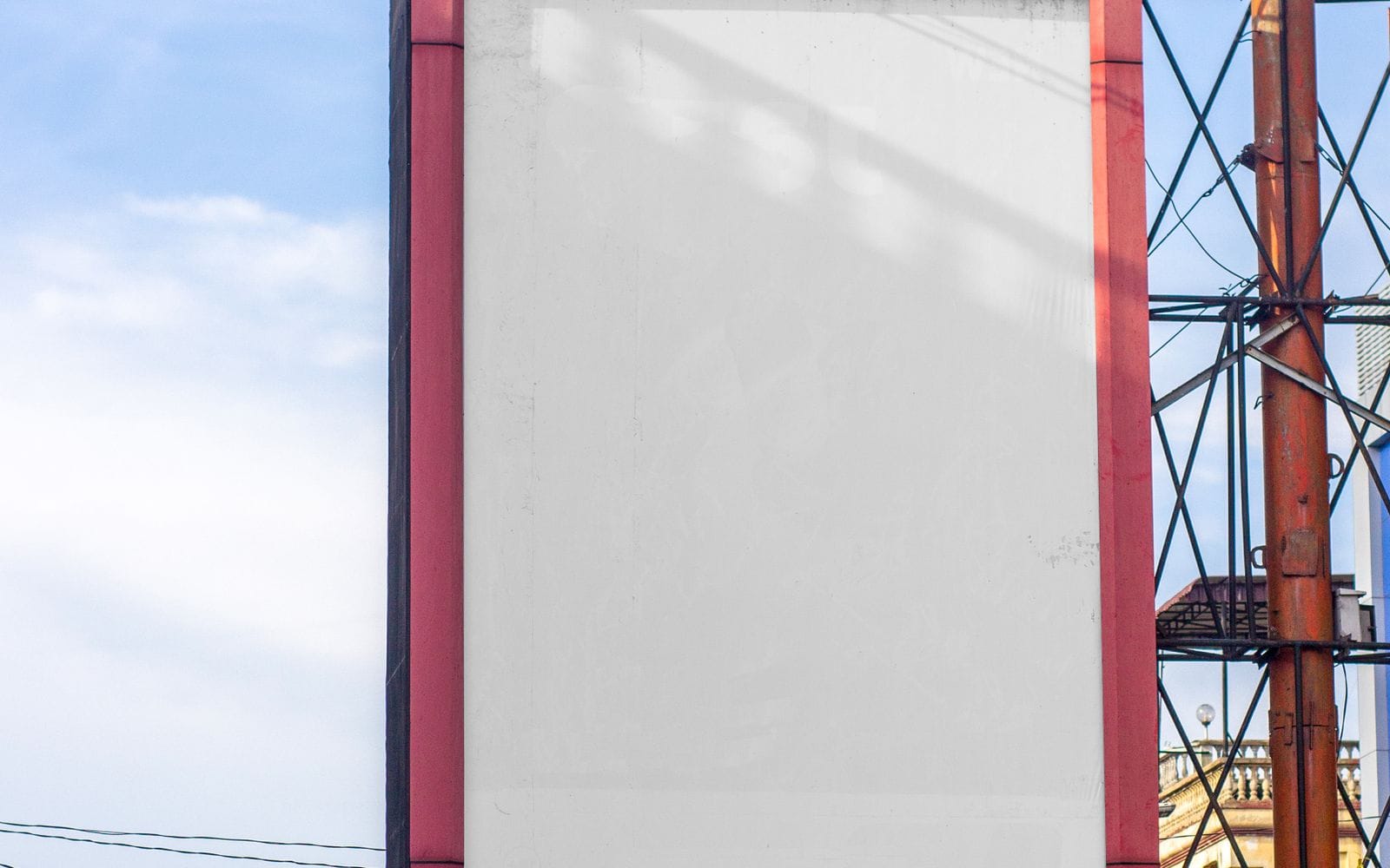 A large blank billboard on a steel frame against a blue sky
