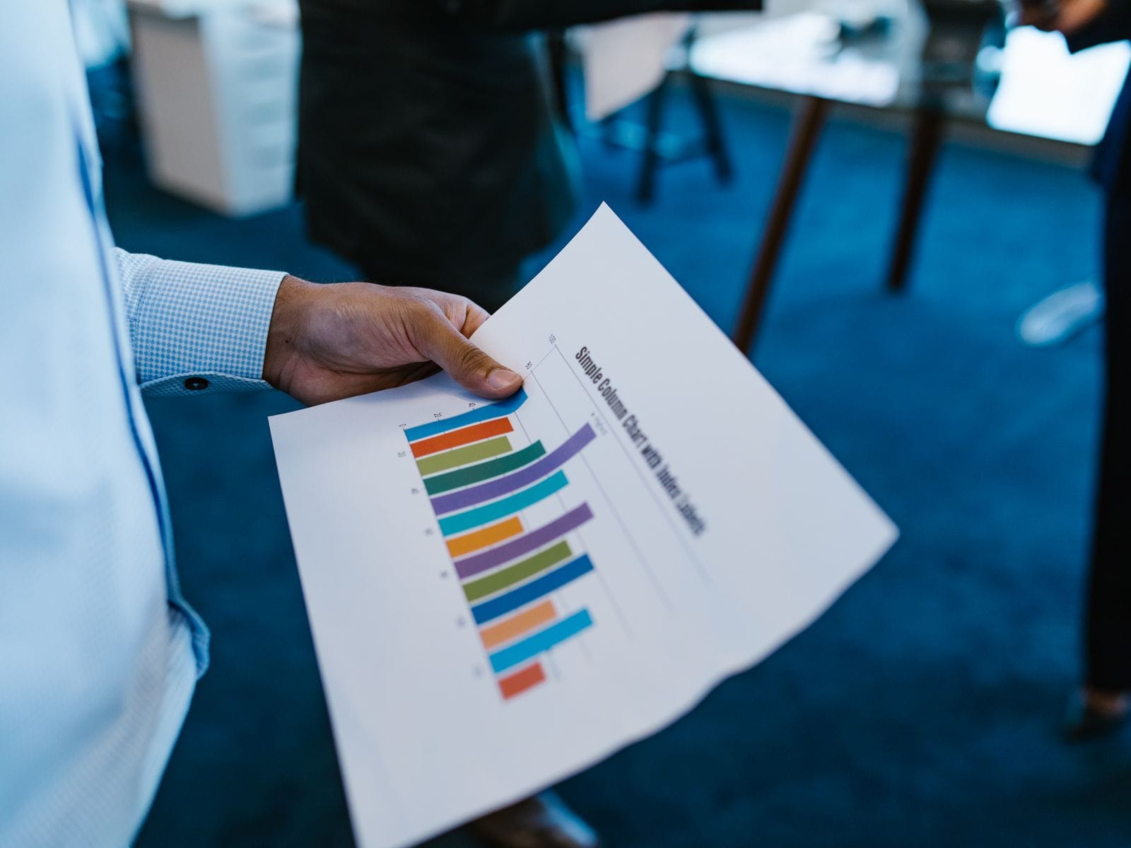 Person reviewing a printed chart of campaign results