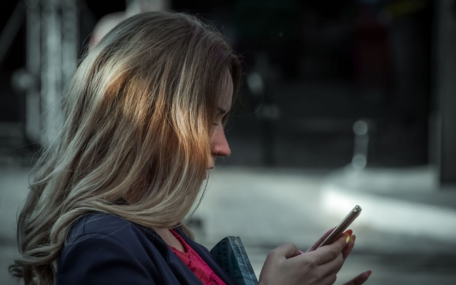 A woman reading something on her smartphone outdoors