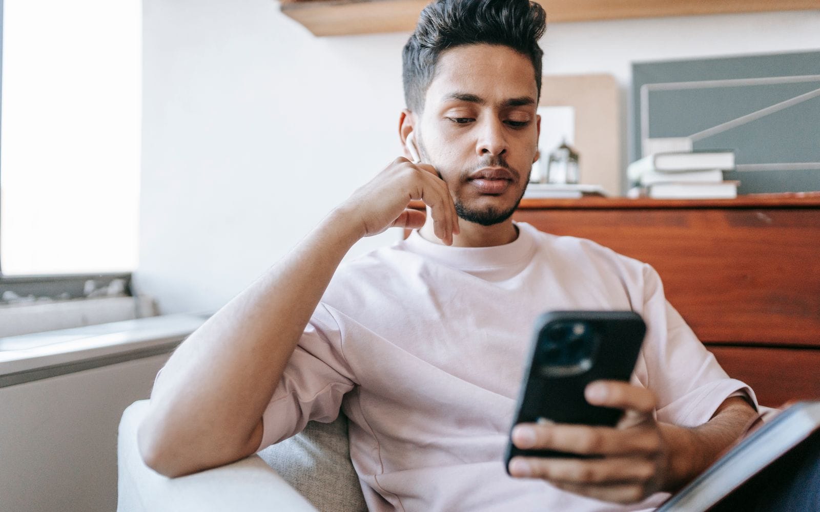 A man reading a WhatsApp message on his phone