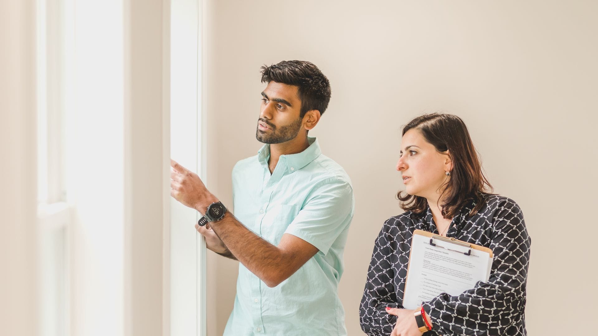 A property agent showing an apartment to a buyer
