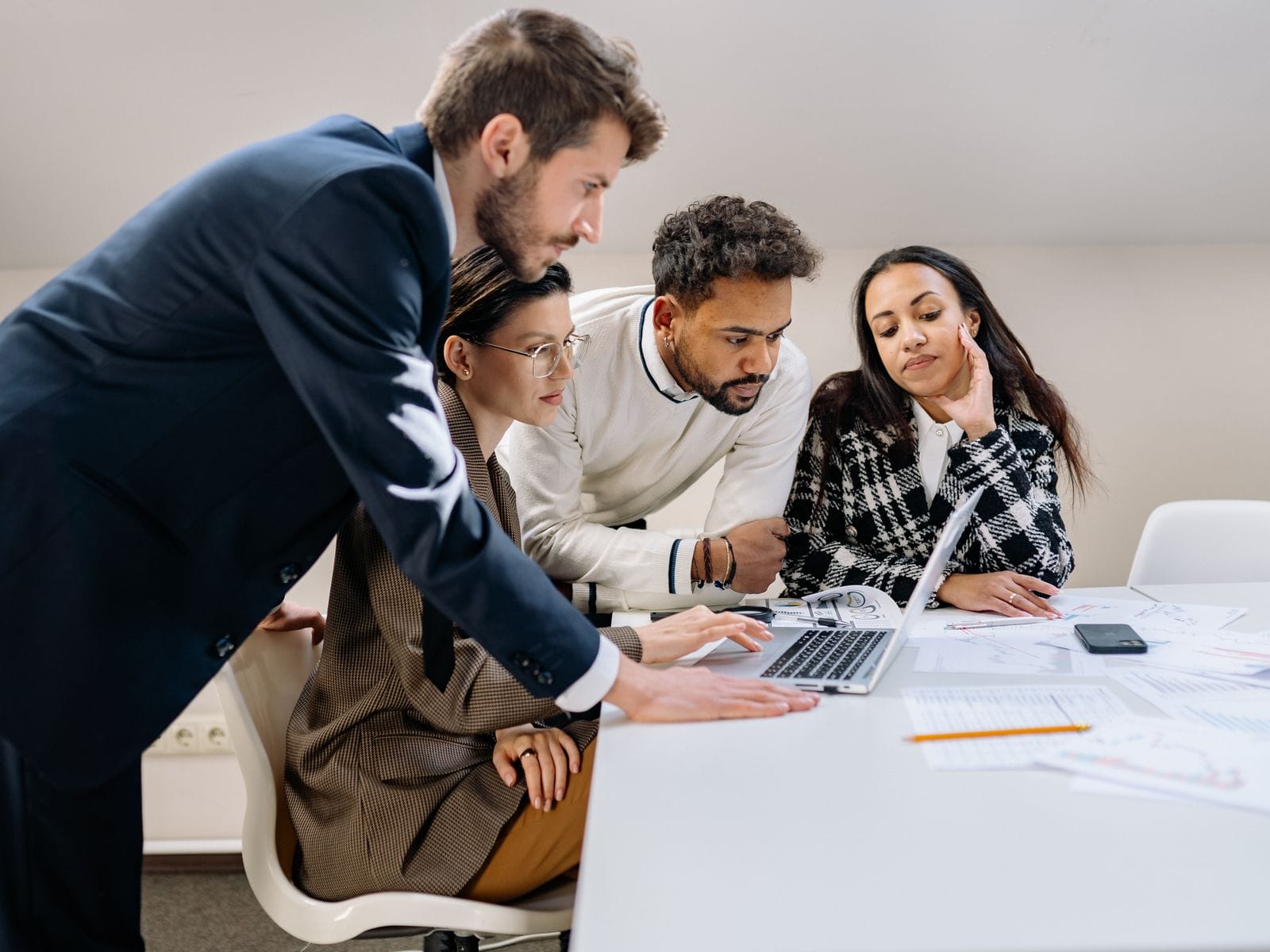 Team discussing plans around a laptop at a meeting table