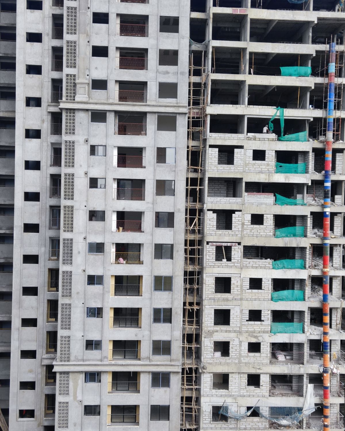 Apartment block under construction, with finished floors next to bare concrete ones