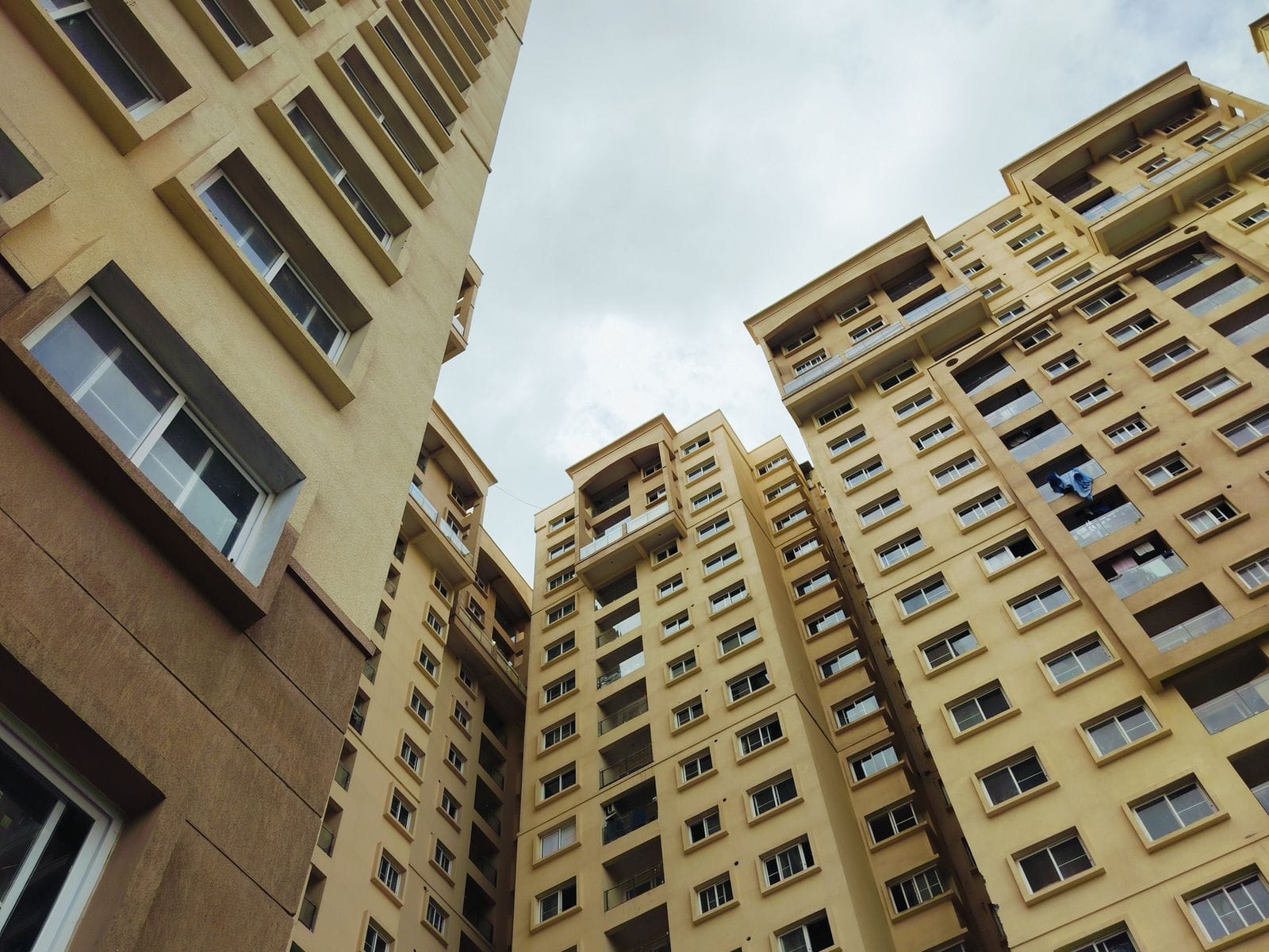 Apartment towers seen from below against a blue sky
