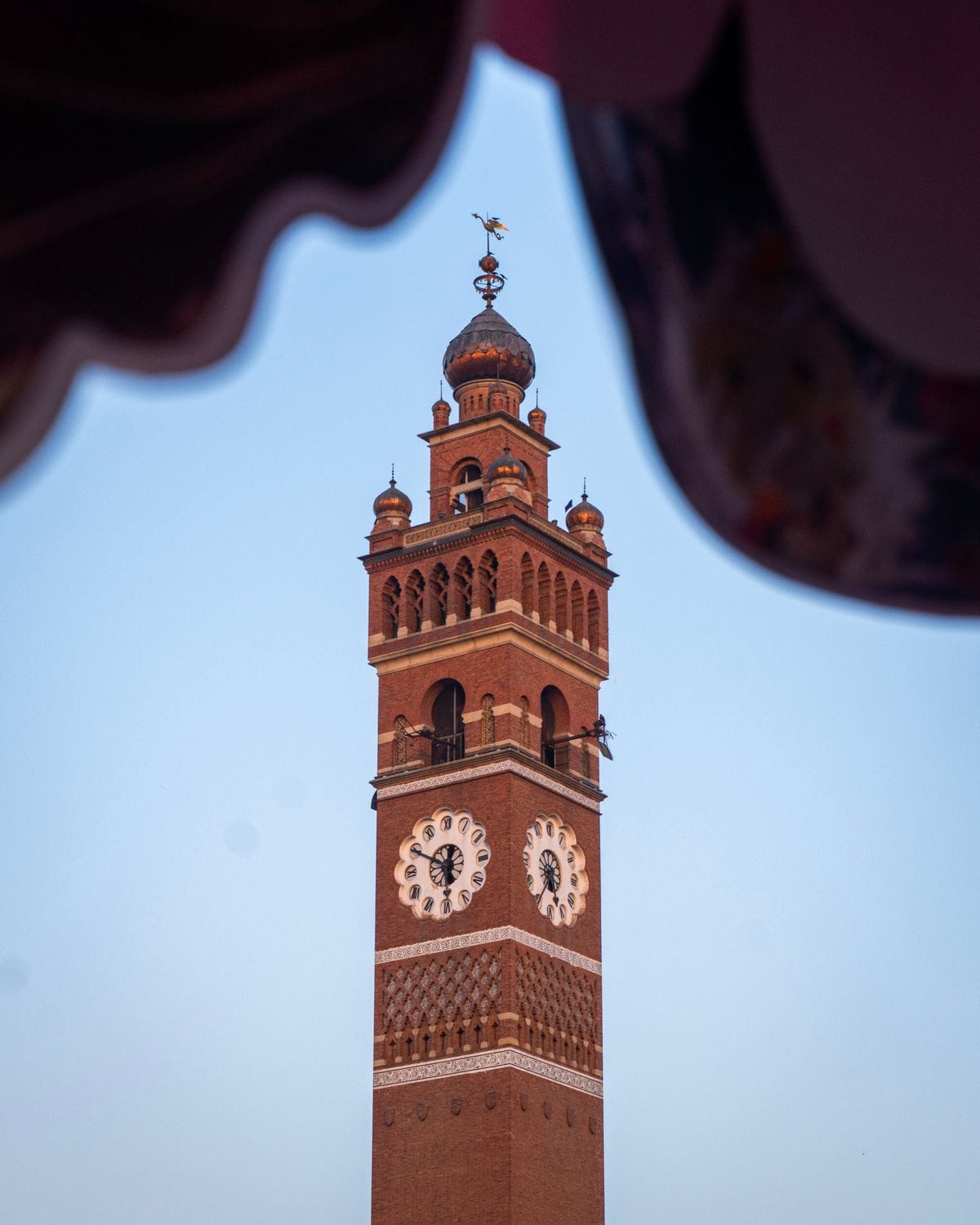 Red-brick clock tower against a clear blue sky