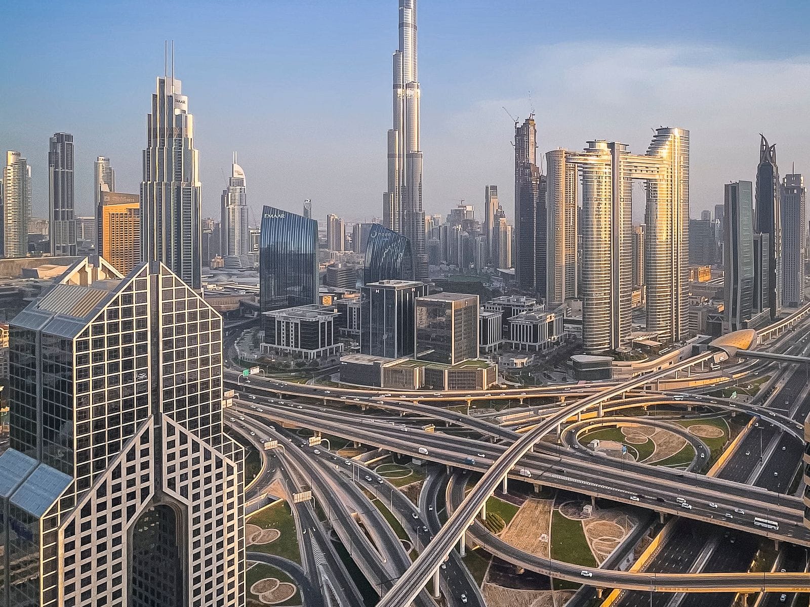 Aerial view of the Dubai skyline with the Burj Khalifa and highway interchanges